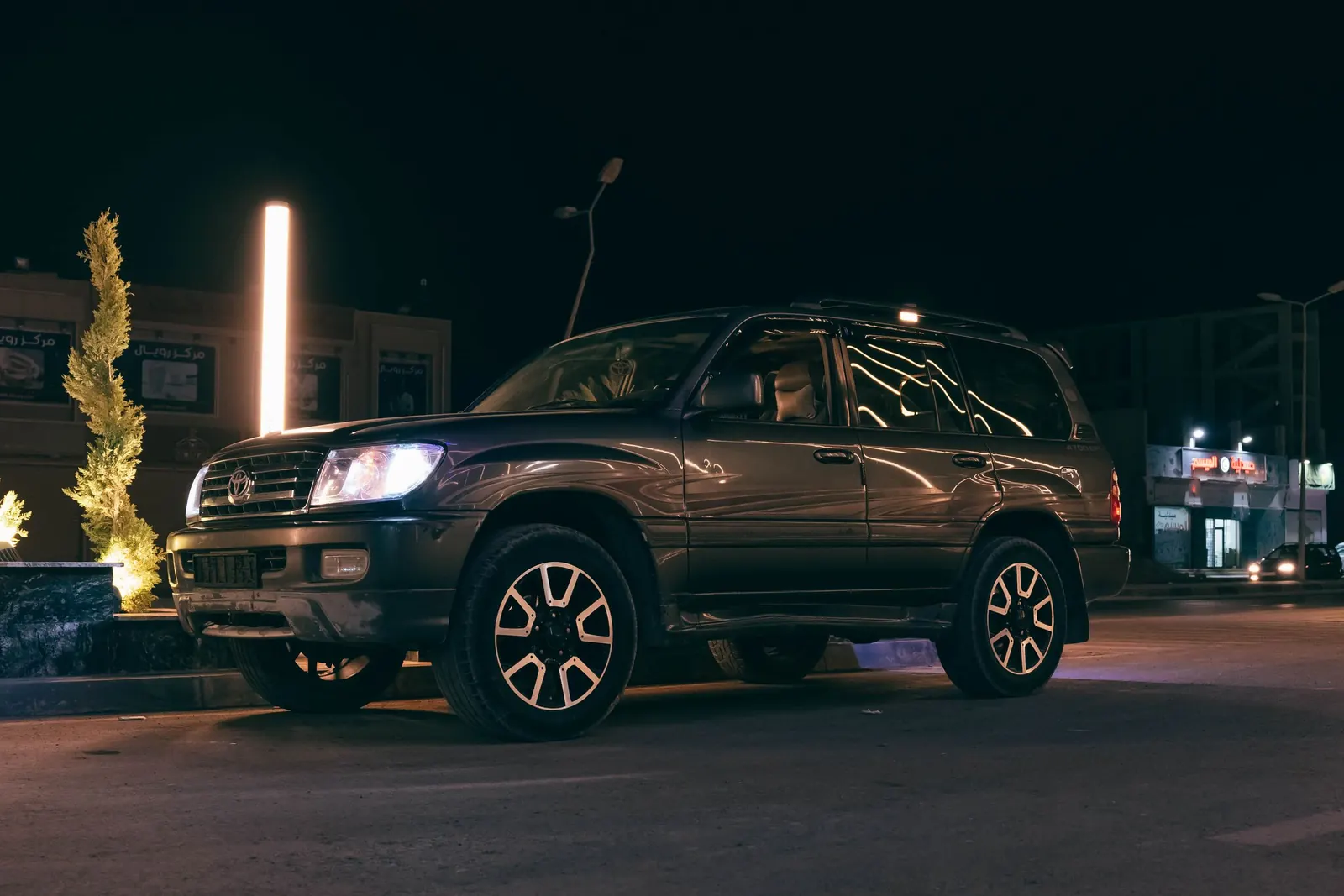 An SUV parked at night